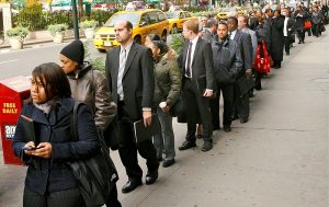 Demandeurs d'emploi américains faisant la queue devant une agence pour l'emploi à New York.