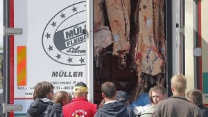 French farmers check the load of a lorry transporting meat as they block trucks that transport food goods coming from foreign countries at the French German border in Strasbourg